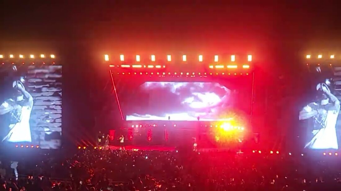 Stage lit red during Sing for the Moment