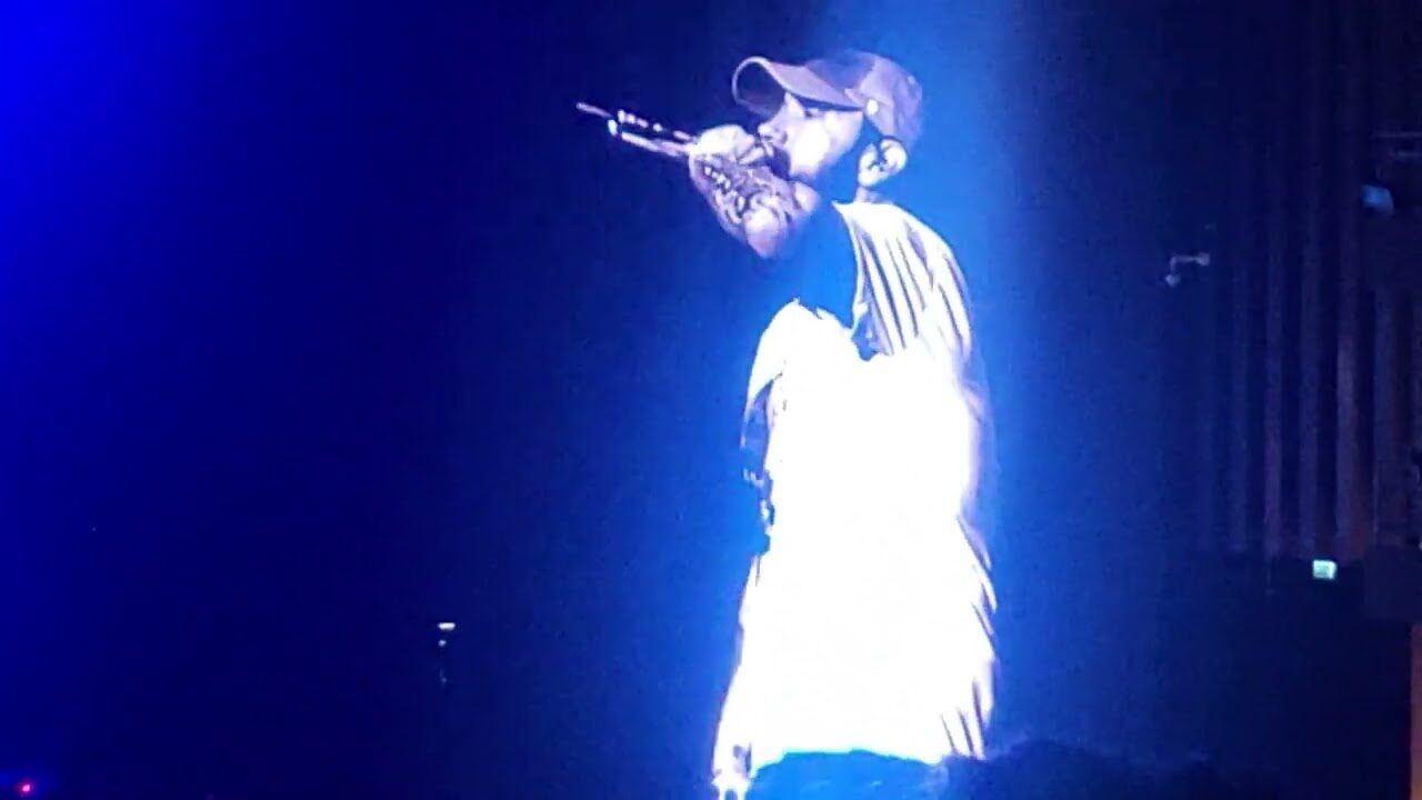 Eminem at the mic in blue light